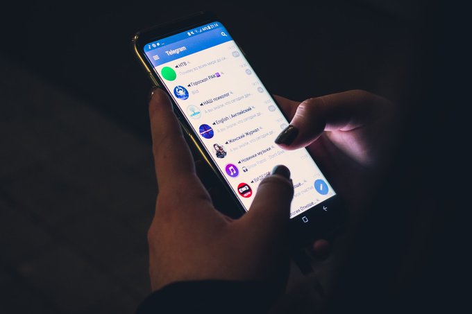 person using telegram app on a phone